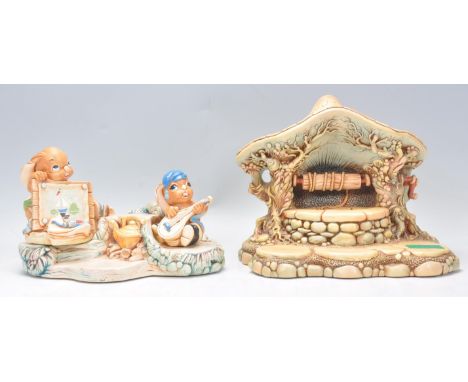 A vintage 20th Century Pendelfin display stand 'Wishing Well' together with another and two Pendelfin&nbsp;rabbit figures. Bi