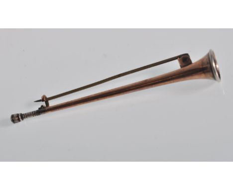 A 19th Century Victorian gold plated brooch in the form of a hunting horn with a hinge pin verso. Measures 8cm.&nbsp;