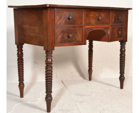 A 19th century George III mahogany bow fronted writing table desk. Raised on bobbin supports having a series of short drawers