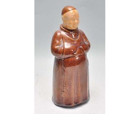 A vintage 20th Century glazed stoneware flask in the form of a monk wearing a brown robe. The head forming the stopper. Measu