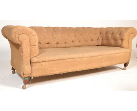 A Victorian 19th century mahogany Chesterfield sofa settee. Raised on square tapering legs with castors supporting a large ba