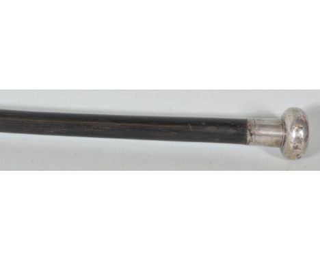 An early 20th Century walking stick cane having a&nbsp;tapering ebonised shaft&nbsp;with silver knop to the top and brass&nbs