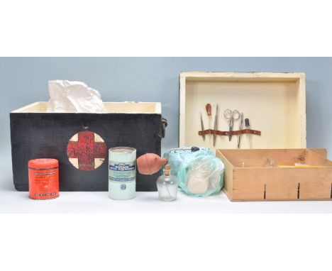 A vintage 20th Century wooden ebonised medical box with a red painted cross to the front. The cover lifts off to reveal a fit