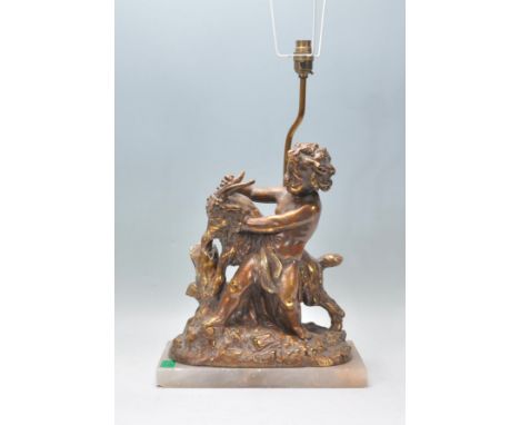 A 20th Century classical style table lamp&nbsp; in the form of a putto with a goat raised on a rectangular marble base.&nbsp;