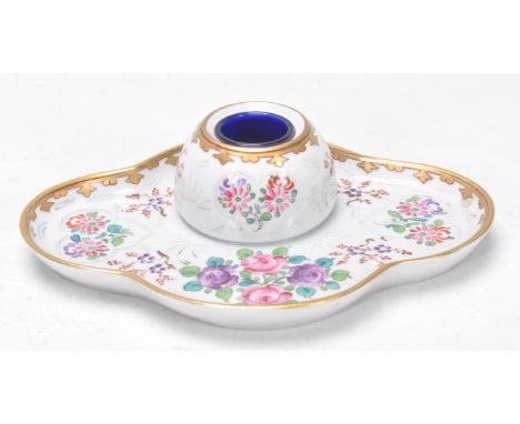 A good 19th Century Dresden inkwell set onto a oval base having ornate hand painted floral sprays and gilt work, including a 