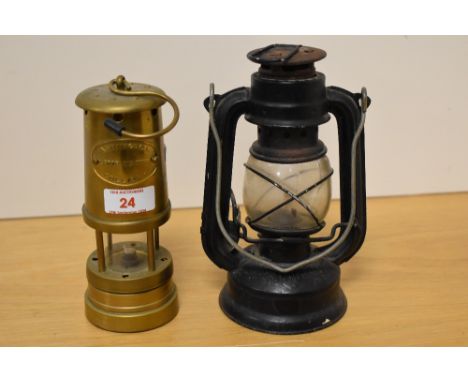 A small vintage kerosene storm lantern sold together with a brass miners type lamp marked 'Ashington Colliery'