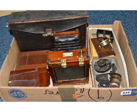 A MAHOGANY QUARTER PLATE CAMERA BY W. WATSON AND SONS, with brass fittings, lens board but no lens, various film backs, a sea