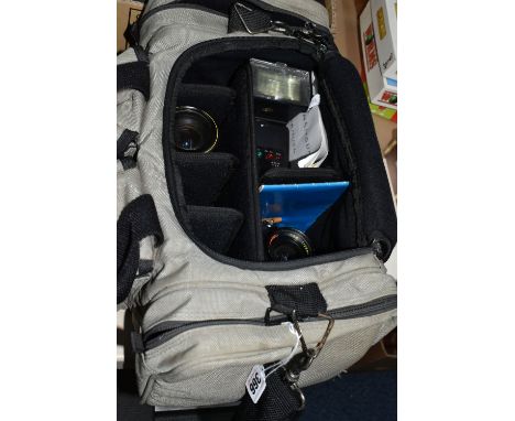 AN OLYMPUS OM10 WITH LENSES IN A CARRYBAG to include a Olympus OM10 fitted with a Bell and Howell 1:28mm lens (without lens c