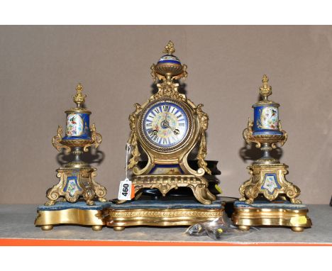 AN ANTIQUE FRENCH GILT METAL MANTEL CLOCK AND GARNITURE SET, the mantel clock has a hand painted porcelain plate with Roman n
