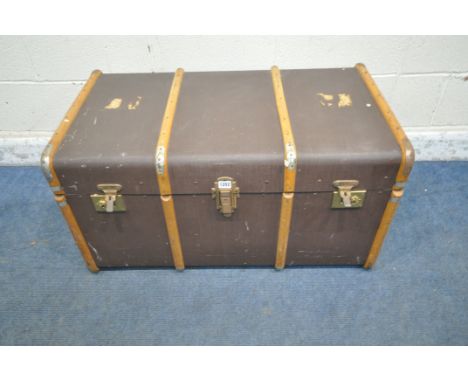 A VINTAGE TRAVELING TRUNK, with wooden banding, and twin leather handles, width 73cm x depth 55cm x height 48cm (condition re