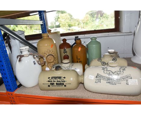 A GROUP OF ELEVEN STONEWARE FOOT WARMERS, comprising two Doulton -Lambeth, a D.B.C and a Philpott's Original, together with a