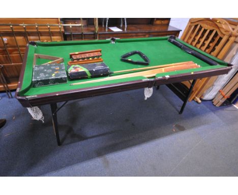 A SLATE BED FOLDING POOL TABLE, with a boxed snooker / billiards set, a set of pool balls, two ball racks, a selection of que