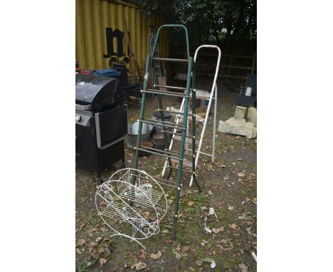 TWO TUBULAR FOLDING STEP LADDERS, along with a circular garden plant stand and a plant holder (4)