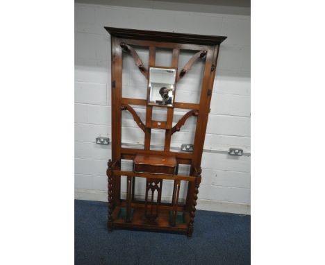 A 20TH CENTURY MAHOGANY HALL STAND, with a central bevelled edge mirror, seven pegs, three hooks, a small shelf, a hinged sto