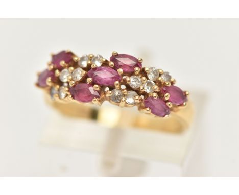 AN 18CT GOLD RUBY AND DIAMOND RING, set with seven oval cut rubies and small round brilliant cut diamond accents, leading ont