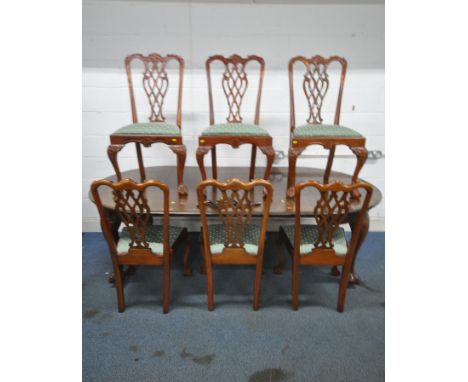 A VICTORIAN MAHOGANY WIND OUT DINING TABLE, with three additional leaves, raised on cabriole legs, with ball and claw feet, e