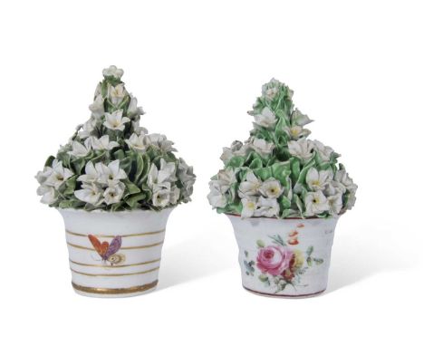 Two Derby porcelain flower pots with ceramic flowers above, the bases also with floral decoration (2)