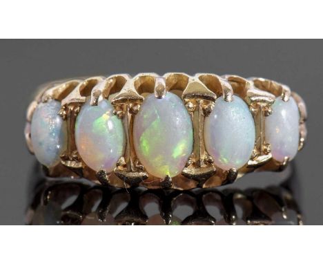 18ct gold five stone opal ring featuring five graduated oval cut cabochon opals, individually claw set in a pierced gallery, 