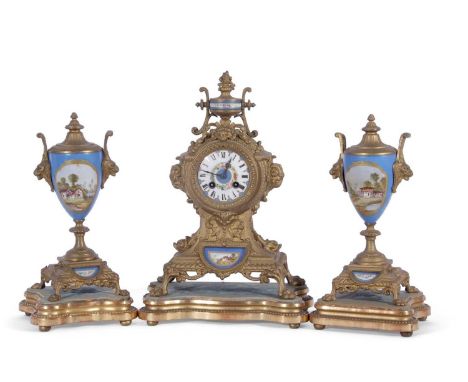 19th century French clock garniture, the clock set in an elaborate gilt metal case with urn shaped mount, the porcelain dial 