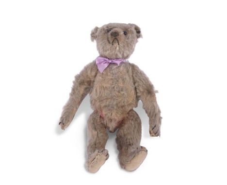 Antique Steiff beige mohair plush teddy bear with wide apart round ears, black button eyes, stitched snout and a humped back,