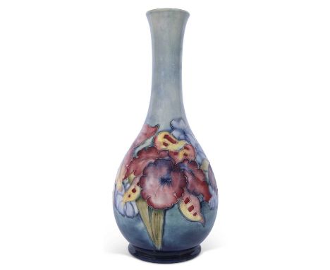 Moorcroft vase decorated with the Orchid pattern on a light green ground, Moorcroft Centenary back stamp to base, 26cm high