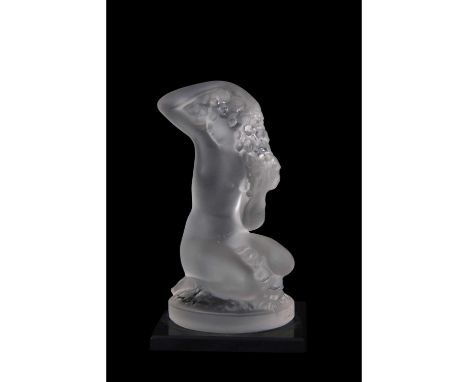 Small Lalique model of a nude lady crouching on circular base, mounted on a black glass rectangular base, 9cm high