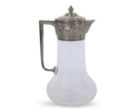 Late Victorian clear glass claret jug with star cut base, angular handle, floral and foliate embossed collar and stepped lid 