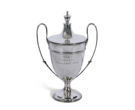 George V silver trophy cup and lid with leaf capped looped handles, urn finial to the push-on lid, gadrooned circular foot, i