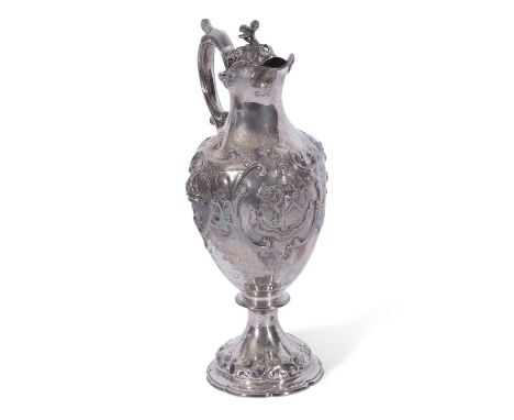 Victorian silver claret jug of tapering baluster form to a shaped circular foot, rococo style embossing throughout and featur