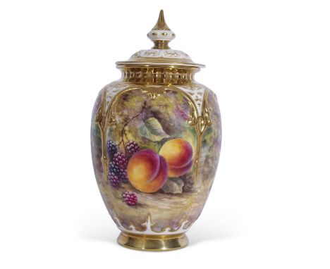 A Royal Worcester vase and reticulated cover decorated with fruit on a mossy ground, signed J Skerrett, 20cm high