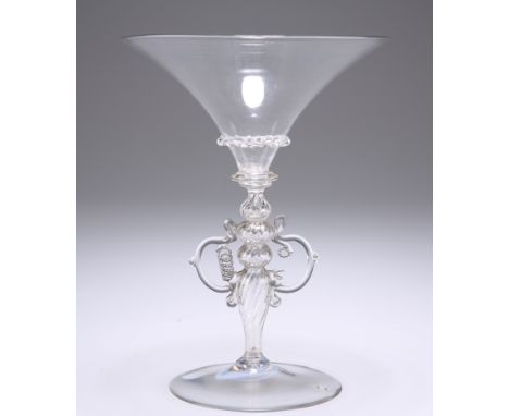 A VENETIAN WINGED WINE GLASS, FIRST HALF OF 17TH CENTURY,&nbsp;the flared bowl applied with a wavy trailed band, above a coll