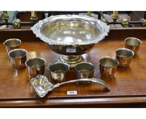A plated punch bowl, ladle and eight cups