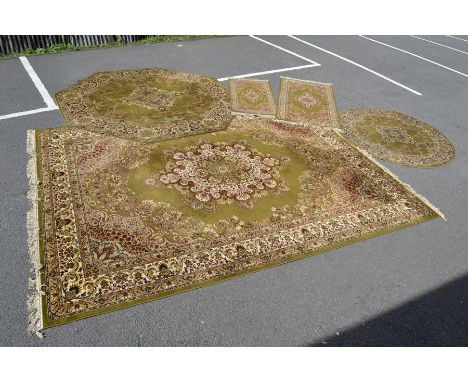 Five Super Keshan power loomed rugs, floral designs in creams and red on a light olive green ground.