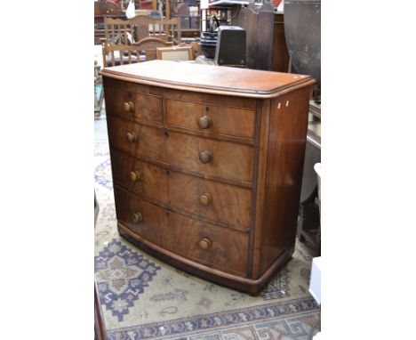 A Victorian mahogany bowfront chest of two short cockbeaded drawers over three graduated long, button handles, bun feet.112cm