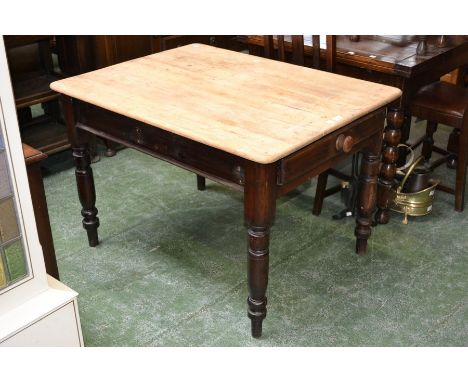 A pine kitchen table, scrubbed top, single drawer to frieze, button handle, turned supports. 72cm high x 106cm long x 82cm wi