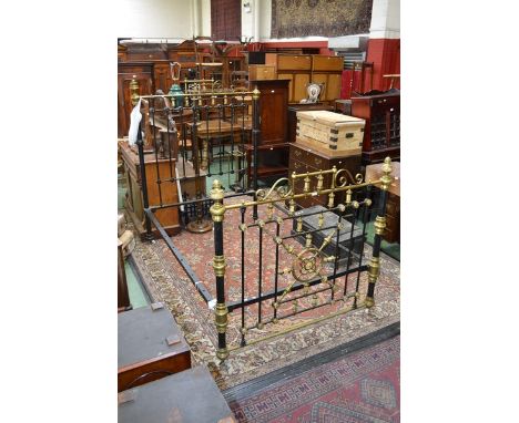 A Victorian brass and metal bed with mother of pearl inlay
