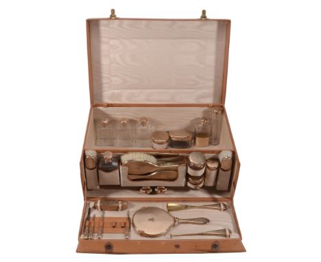  A pigskin travelling case with 9 carat gold mounted fittings, mainly by L. A. Leins & Sons, mainly London 1926, the fittings