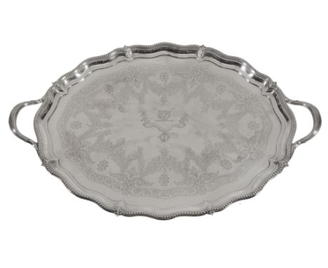  A late Victorian silver shaped oval twin handled tray by Henry Wilkinson & Co., London 1894, the twin moulded handles with b