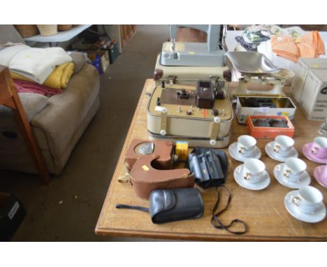 A pair of binoculars; together with a Brownie projector sold as collectors item; a miniature sewing machine in fitted case et