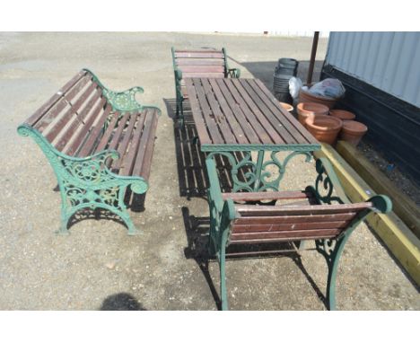 A wooden and metal garden table with matching arm chairs; and a wooden and metal garden bench (AF)