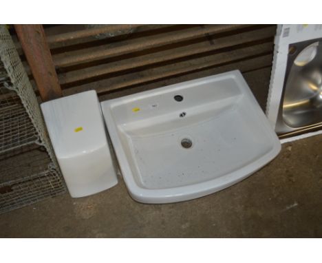 A ceramic bathroom sink and pedestal 