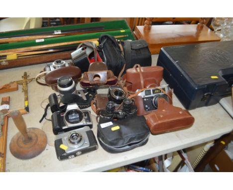 A quantity of cameras to include Minolta; a pair of binoculars etc