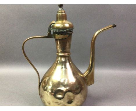 OTTOMAN BRASS EWER AND BASIN EARLY-MID 20TH CENTURY the ewer with hinged domed lid, loop handle and slender spout, on a basin