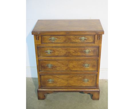 A Georgian style walnut bachelors chest with a fold over top, above four drawers, on bracket feet, made by a local craftsman 