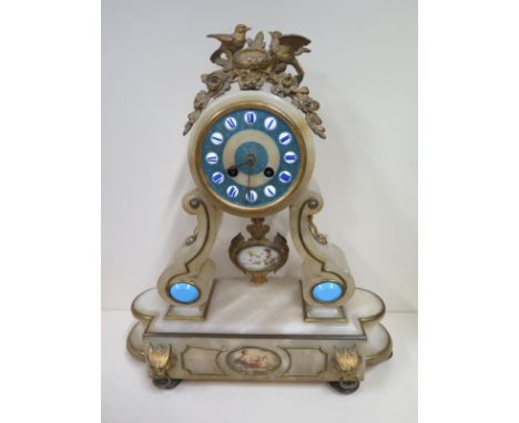 An ormulu and alabaster mantle clock 43cm tall, some general wear to clock, ticks but stops, needs some restoration 