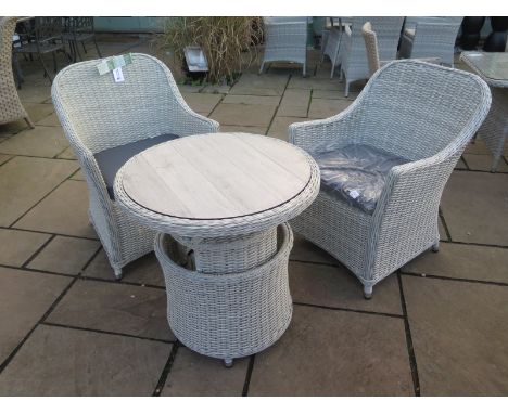 A Bramblecrest pair of armchairs and an adjustable table with a ceramic top 