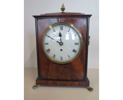 A Regency brass inlaid mahogany bracket clock with an arch top fusee movement standing 36cm tall, on brass hairy claw feet, s