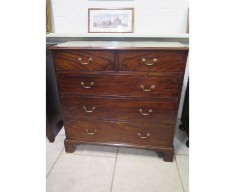 A good quality Georgian mahogany and inlaid chest with two short over three long drawers with brass handles raised on bracket