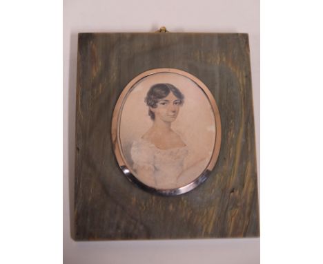 An early 19th Century portrait miniature of a lady wearing a white dress, watercolour and pencil on card, in an attractive ho