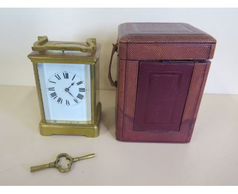 A French brass carriage clock striking on a gong with repeat, with outer case, 15cm tall, small chips to front glass, otherwi